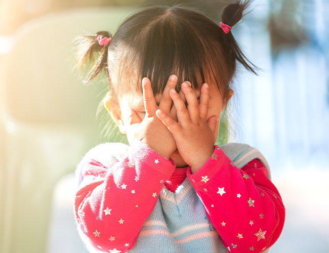 10 - 12 month old playing peek-a-boo.